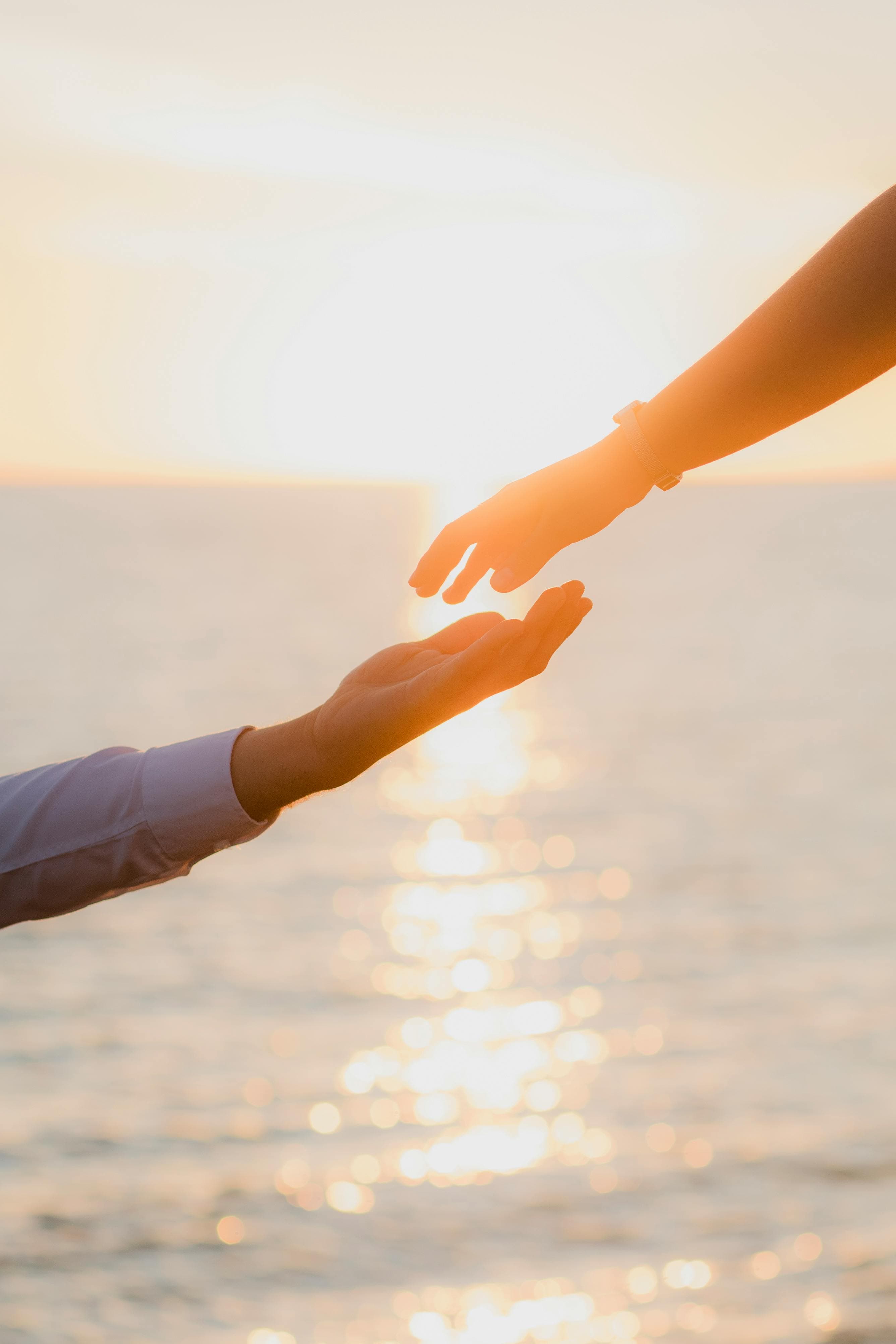 Free Captivating image of hands reaching out against a sunset in Sinaloa, evoking love and connection.